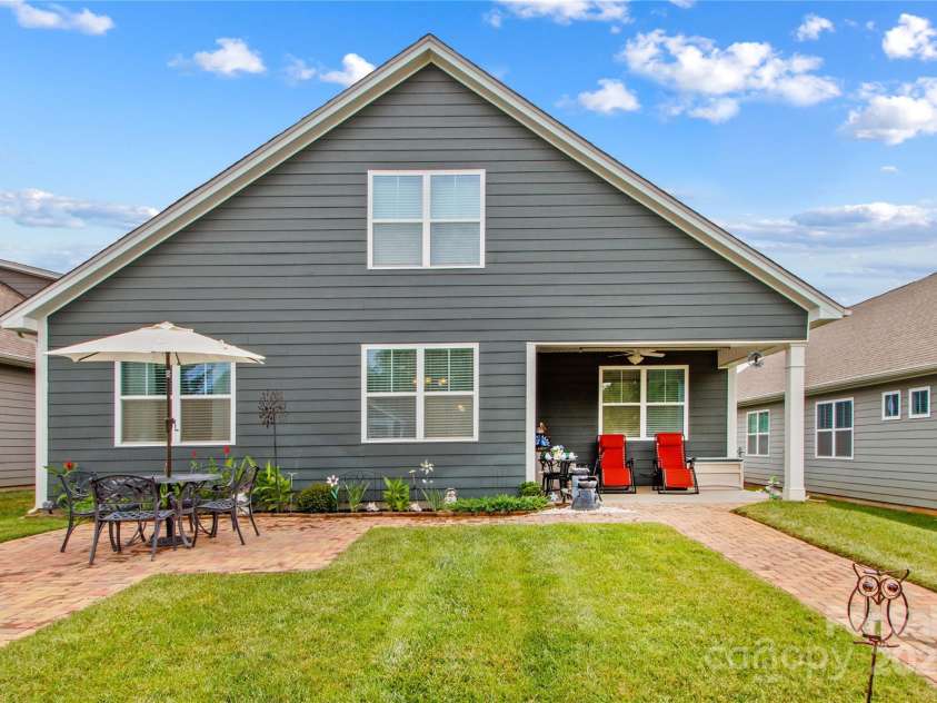 117 Cup Chase Drive, Mooresville, NC 28115.  MLS# CAR4279101, YatesRealty ID 25558. 117 Cup Chase Rear with interlocking stone walkway and dining patio