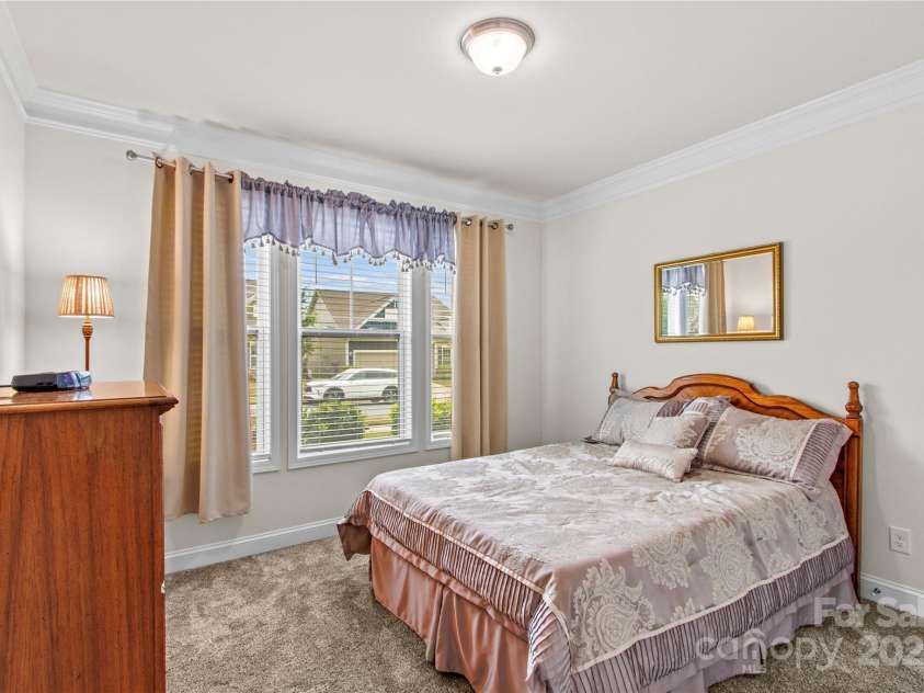 117 Cup Chase Drive, Mooresville, NC 28115.  MLS# CAR4279101, YatesRealty ID 25558. Bedroom 2 with new carpeting, crown molding.