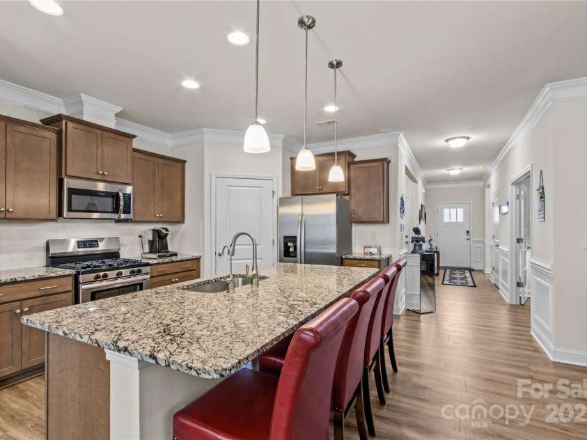 117 Cup Chase Drive, Mooresville, NC 28115.  MLS# CAR4279101, YatesRealty ID 25558. Kitchen granite countertop, pendant lighting view to front entry