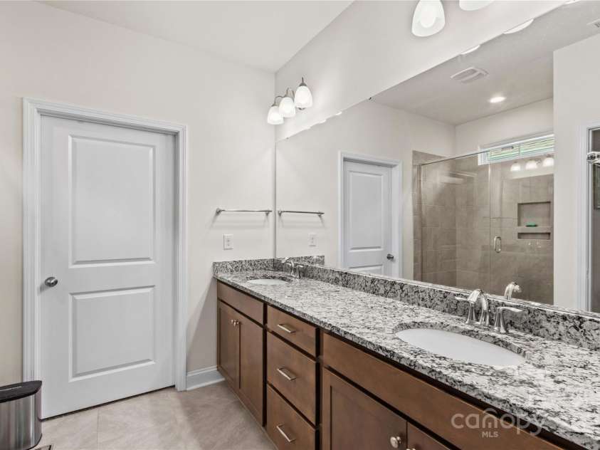 117 Cup Chase Drive, Mooresville, NC 28115.  MLS# CAR4279101, YatesRealty ID 25558. Primary bath with dual sinks, granite countertop, tile flooring