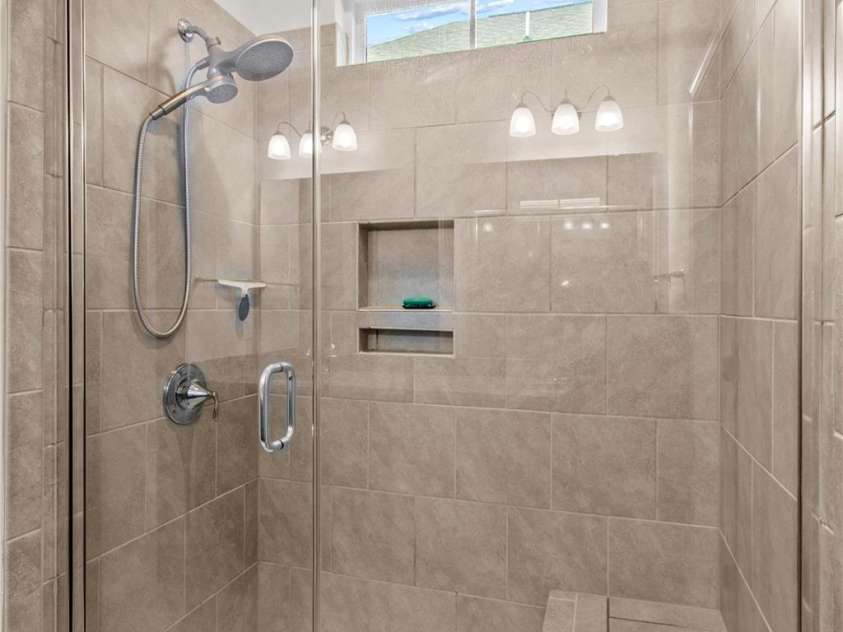 117 Cup Chase Drive, Mooresville, NC 28115.  MLS# CAR4279101, YatesRealty ID 25558. Primary luxury tile shower with seat and toiletry niche