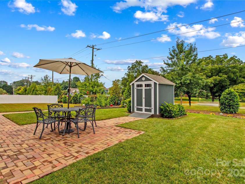 117 Cup Chase Drive, Mooresville, NC 28115.  MLS# CAR4279101, YatesRealty ID 25558. Rear view dining patio, shed and backs onto Hwy 3 berm