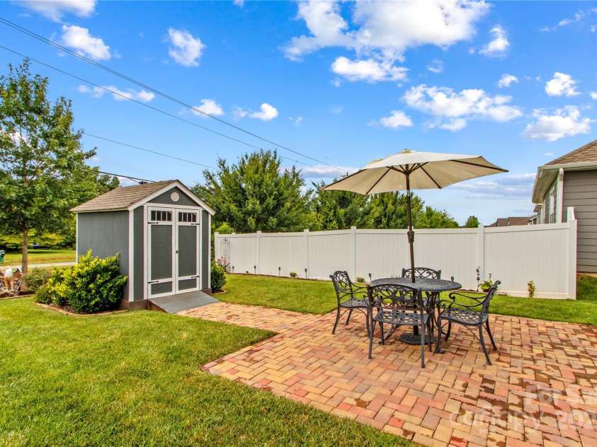 117 Cup Chase Drive, Mooresville, NC 28115.  MLS# CAR4279101, YatesRealty ID 25558. Rear yard dining patio and shed