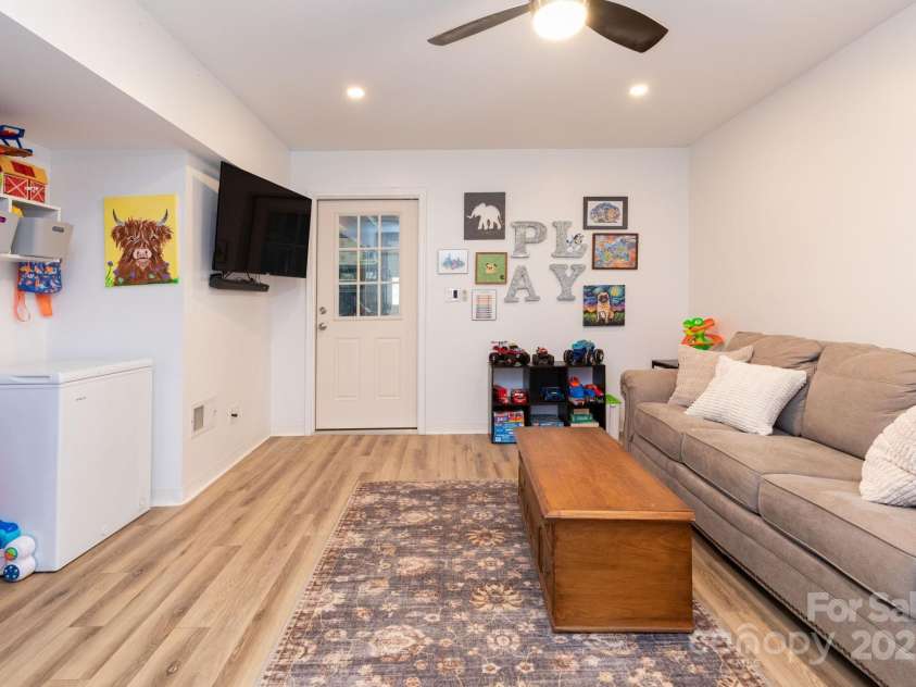 14 New Bern Drive, Fletcher, NC 28732.  MLS# CAR4277461, YatesRealty ID 25567. Family room in lower level