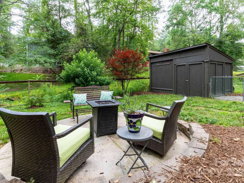 14 New Bern Drive, Fletcher, NC 28732.  MLS# CAR4277461, YatesRealty ID 25567. Fire pit area and large shed
