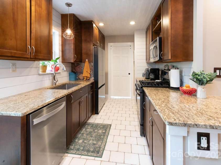 14 New Bern Drive, Fletcher, NC 28732.  MLS# CAR4277461, YatesRealty ID 25567. Galley kitchen with granite counters