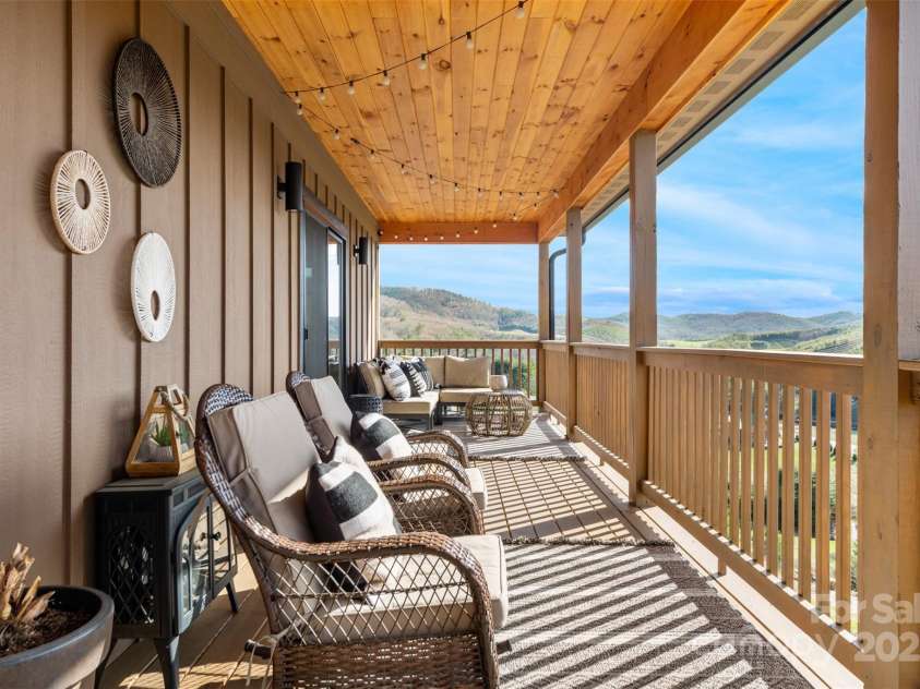 527 Cedar Trail, Fleetwood, NC 28626.  MLS# CAR4271536, YatesRealty ID 25576. Large wrap around deck runs width of the house