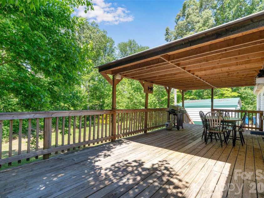 5029 Mundy Lane, Denver, NC 28037.  MLS# CAR4379646, YatesRealty ID 25585. Large back deck partially covered, overlooking your acreage