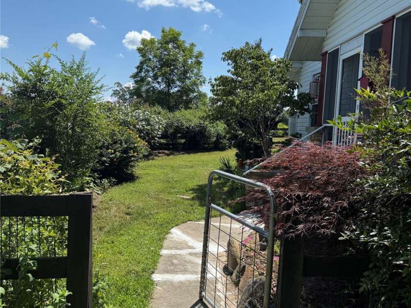 5188 Dysartsville Road, Morganton, NC 28655.  MLS# CAR4270470, YatesRealty ID 25587. Enter through the gate to bountiful flowers & lush green grass