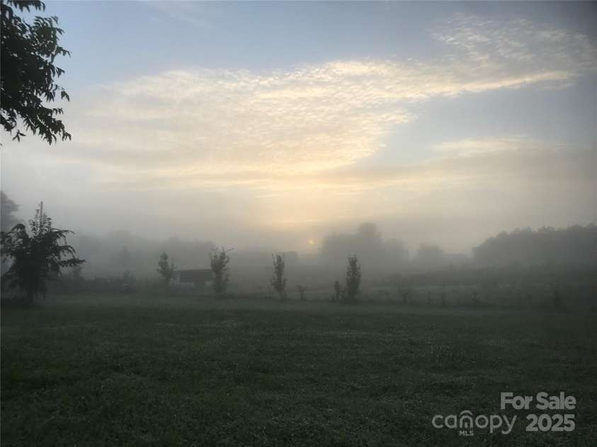 5188 Dysartsville Road, Morganton, NC 28655.  MLS# CAR4270470, YatesRealty ID 25587. Experience an endless and ever-changing landscape beyond the horizon comfortably from this one-of-a-kind homestead. The current picture captures a misty sunrise.