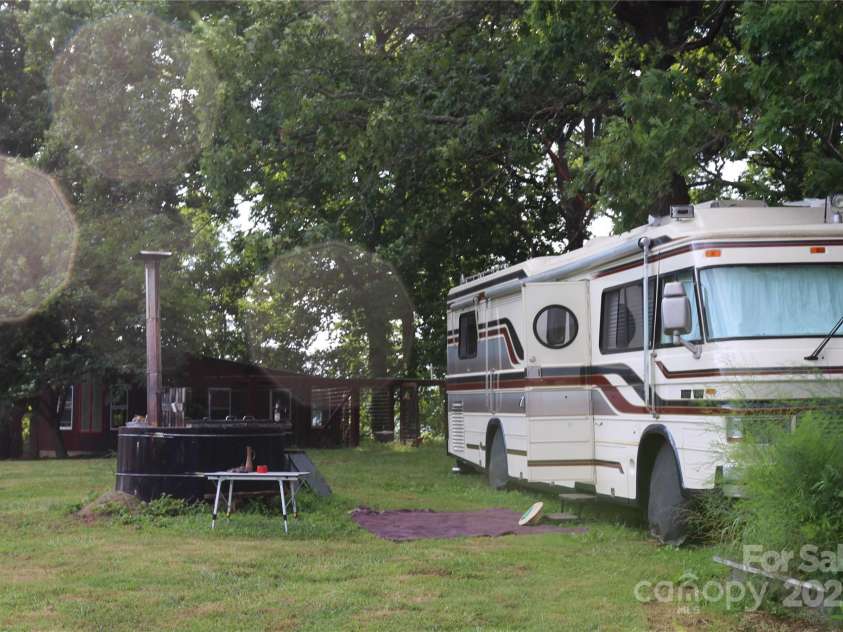 5188 Dysartsville Road, Morganton, NC 28655.  MLS# CAR4270470, YatesRealty ID 25587. Motorhome beside the hot tub will be available for purchase. Smokehouse is located at the rear of the motorhome.