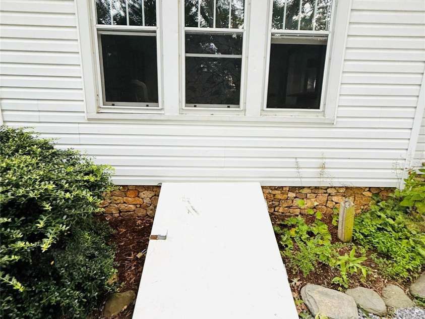 5188 Dysartsville Road, Morganton, NC 28655.  MLS# CAR4270470, YatesRealty ID 25587. Outside basement entry where you'll find additional storage, solar battery system, sump pump, dehumidifier, and 8