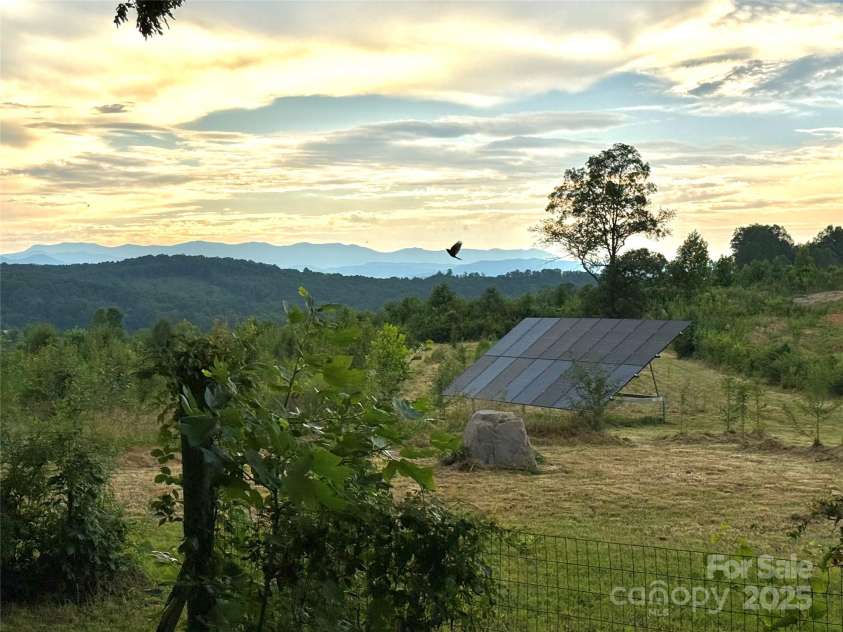 5188 Dysartsville Road, Morganton, NC 28655.  MLS# CAR4270470, YatesRealty ID 25587. Solar panels in field with gorgeous sunset views from the back of the home. Potential area for another home with well already installed.