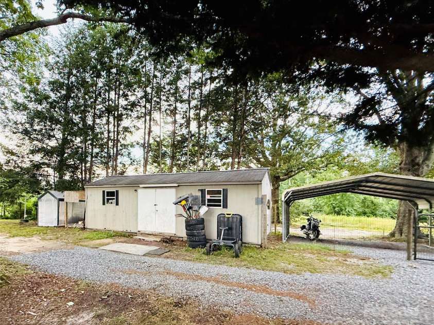 5188 Dysartsville Road, Morganton, NC 28655.  MLS# CAR4270470, YatesRealty ID 25587. Tool shed with electric, carport, plus additional farm storage to the left of the tool shed.