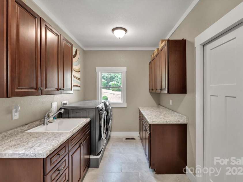 232 Sanctuary Way, Marshall, NC 28753.  MLS# CAR4151690, YatesRealty ID 2559. Large laundry room with access outside.