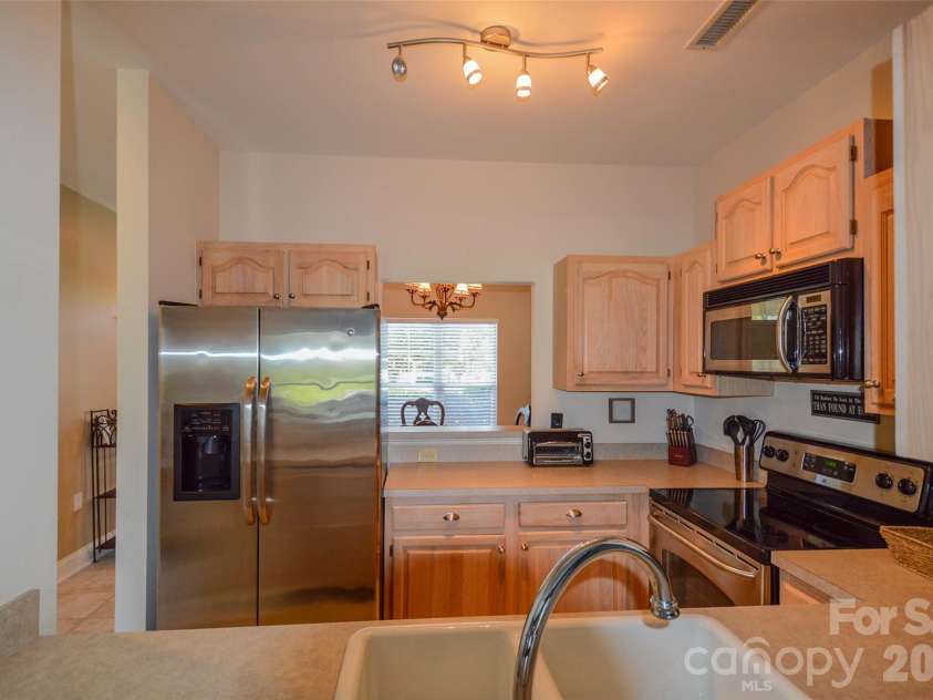 18821 Silver Quay Drive, Cornelius, NC 28031.  MLS# CAR4385275, YatesRealty ID 25590. Kitchen has access to both dining and living areas, the cook is never alone!
