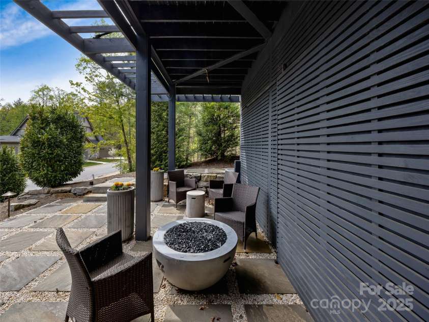 11 Bayonne Trail, Asheville, NC 28804.  MLS# CAR4250937, YatesRealty ID 256. Terrace level patio with a large screened storage for sports and bike equipment