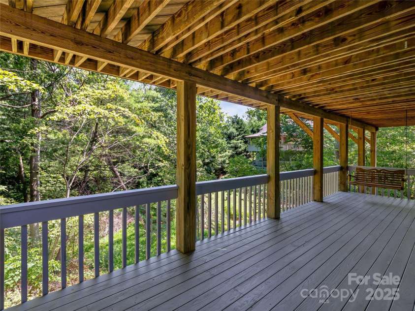 15 Josie Lane, Asheville, NC 28804.  MLS# CAR4267663, YatesRealty ID 25606. Lower deck with porch swing