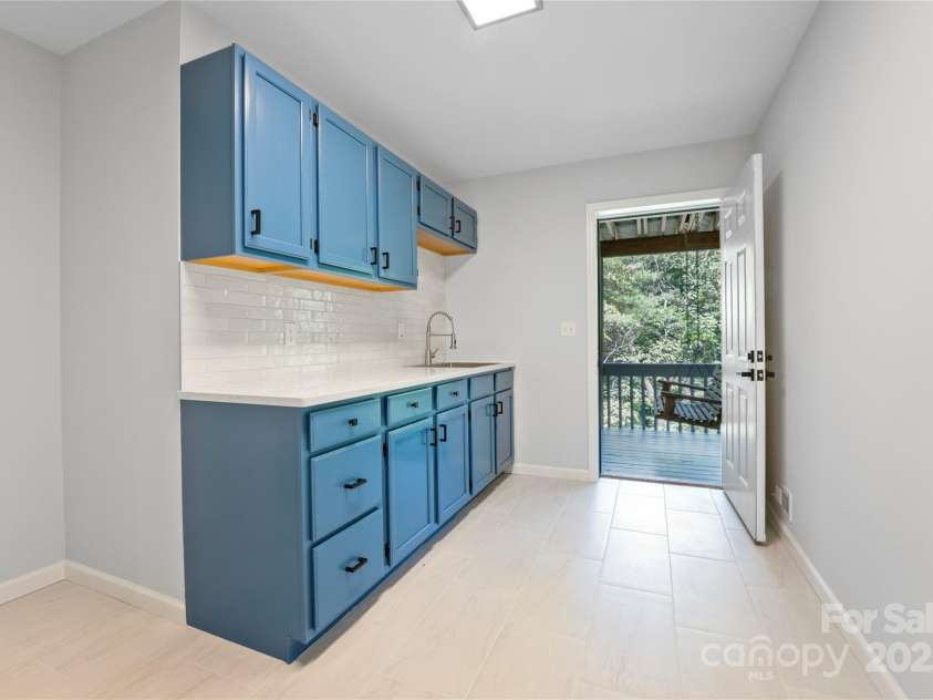 15 Josie Lane, Asheville, NC 28804.  MLS# CAR4267663, YatesRealty ID 25606. Lower level kitchenette; door to lower deck