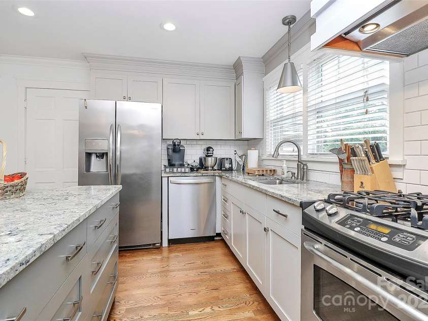 427 Lansdowne Road, Charlotte, NC 28270.  MLS# CAR4278701, YatesRealty ID 25638. Please note pantry on left of laundry room features pull out shelving!