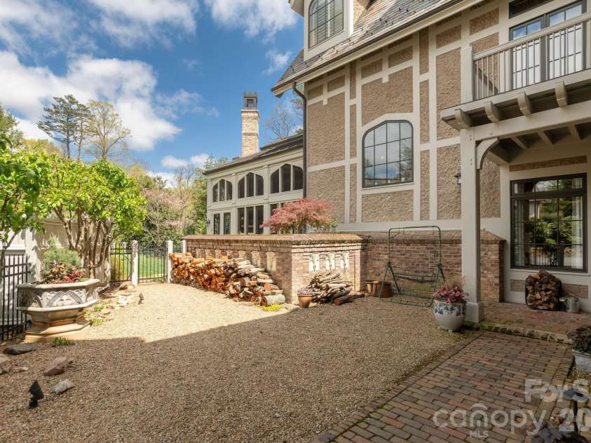 8 Fairway Place, Asheville, NC 28803.  MLS# CAR4245541, YatesRealty ID 2564. Back entrance with gravel courtyard open to raised garden beds and lined with cherry trees