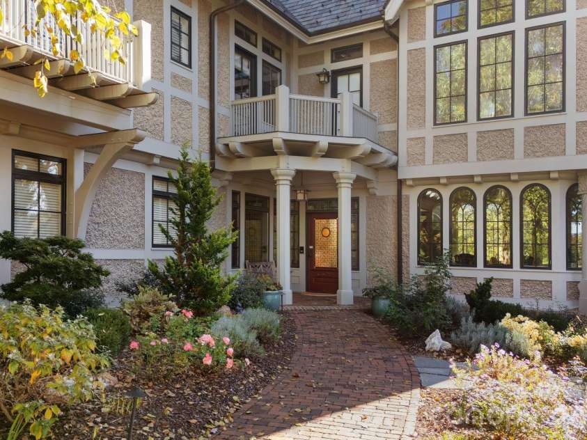 8 Fairway Place, Asheville, NC 28803.  MLS# CAR4245541, YatesRealty ID 2564. Stately front entrance with roses and lavendar.  Magnificent home on the 7th fairway of Biltmore Forest Country Club