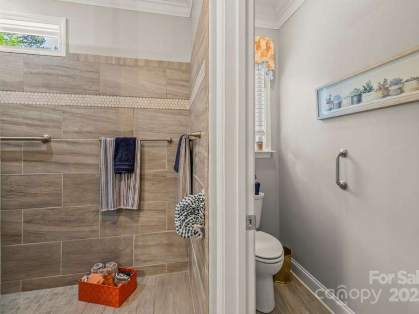 1150 Golden Hill Lane, Denver, NC 28037.  MLS# CAR4278089, YatesRealty ID 25650. Dual showerheads, and built-in bench seating. Textured tile accents and a calming palette add a boutique hotel feel.