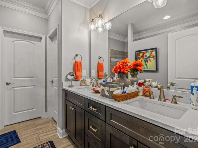 1150 Golden Hill Lane, Denver, NC 28037.  MLS# CAR4278089, YatesRealty ID 25650. Tile flooring with a wood look complement the flooring as does the double bowl vanity with quartz countertops