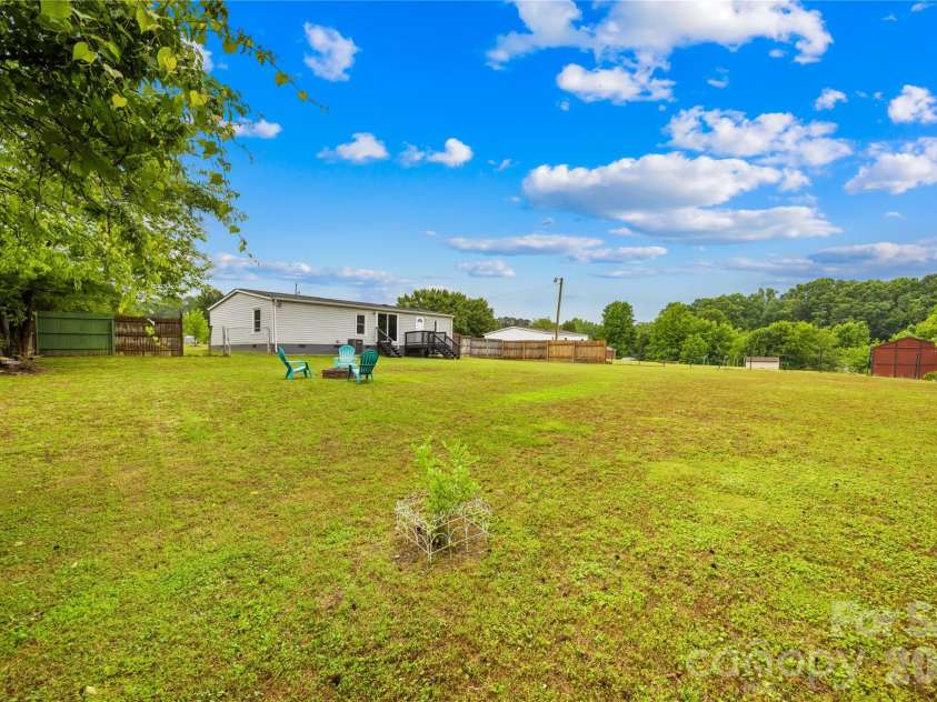 139 Gayle Drive, Troutman, NC 28166.  MLS# CAR4375168, YatesRealty ID 25654. Spacious backyard with fire pit