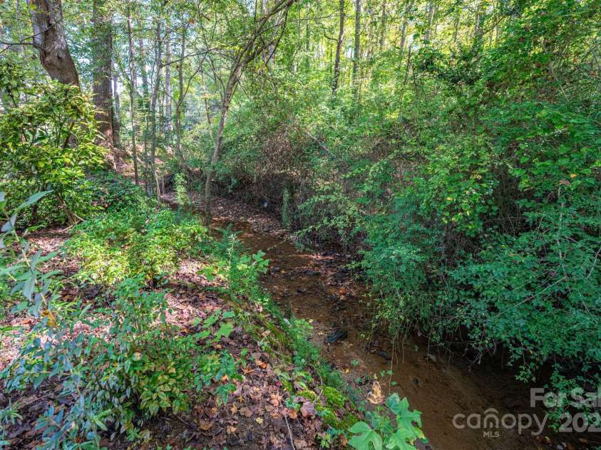 217 Rock Creek Drive, Lincolnton, NC 28092.  MLS# CAR4307464, YatesRealty ID 25675. Creek at back of property