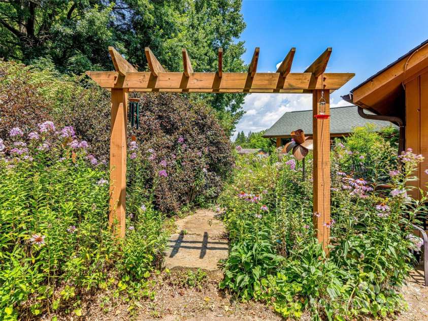 703 Crestview Drive, Leicester, NC 28748.  MLS# CAR4055999, YatesRealty ID 2568. Manicured garden spaces can be found throughout the property.