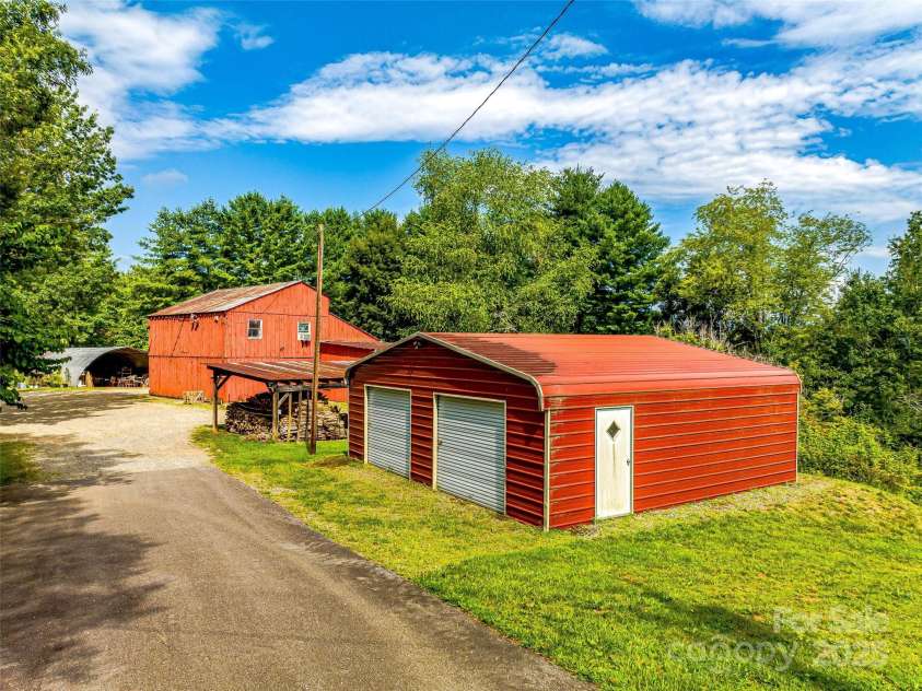 703 Crestview Drive, Leicester, NC 28748.  MLS# CAR4055999, YatesRealty ID 2568. Metal garage building and two story barn.