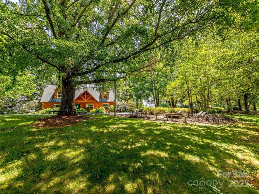 703 Crestview Drive, Leicester, NC 28748.  MLS# CAR4055999, YatesRealty ID 2568. Sit a spell under the mature tree canopy and enjoy the rolling lawn and pasture areas.