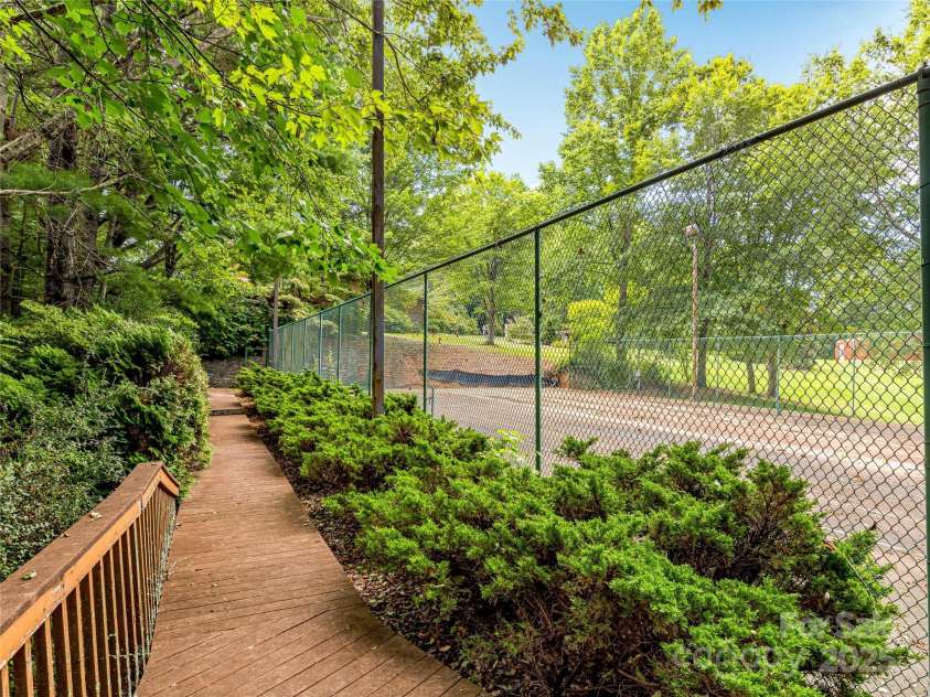 703 Crestview Drive, Leicester, NC 28748.  MLS# CAR4055999, YatesRealty ID 2568. Tennis Court overlooking pool area