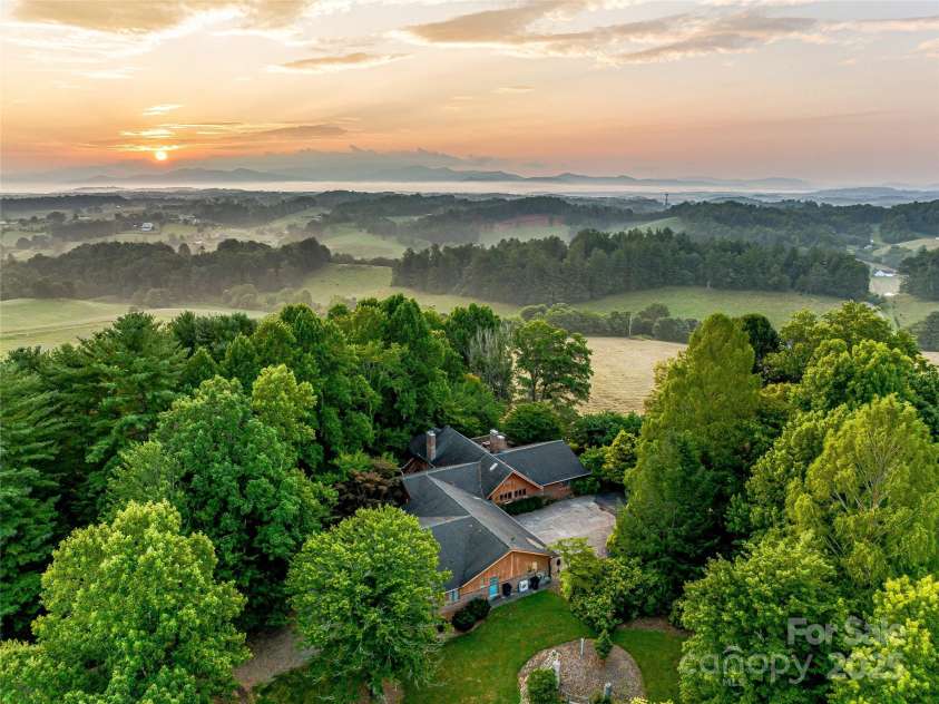 703 Crestview Drive, Leicester, NC 28748.  MLS# CAR4055999, YatesRealty ID 2568. Three houses perfectly spaced on a gentle ridgeline with views to the East.