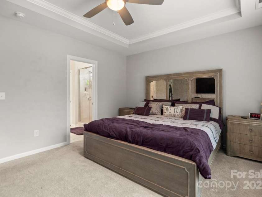 219 Broadleaf Drive, Denver, NC 28037.  MLS# CAR4265284, YatesRealty ID 25691. A tray ceiling and fan accentuate the primary bedroom