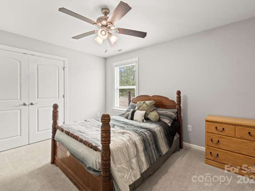 219 Broadleaf Drive, Denver, NC 28037.  MLS# CAR4265284, YatesRealty ID 25691. Bedroom 3 features neutral paint and carpeting as well as a ceiling fan