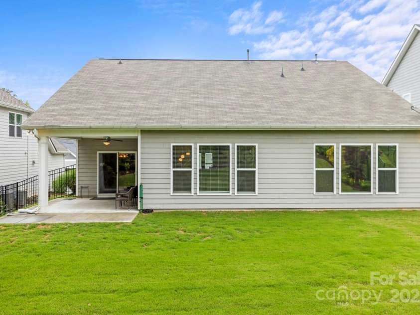 219 Broadleaf Drive, Denver, NC 28037.  MLS# CAR4265284, YatesRealty ID 25691. Rear view of home displaying the walls of windows