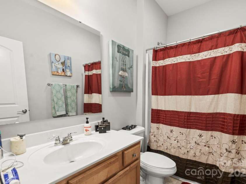 219 Broadleaf Drive, Denver, NC 28037.  MLS# CAR4265284, YatesRealty ID 25691. The second full bathroom features tile flooring and is located on the main level