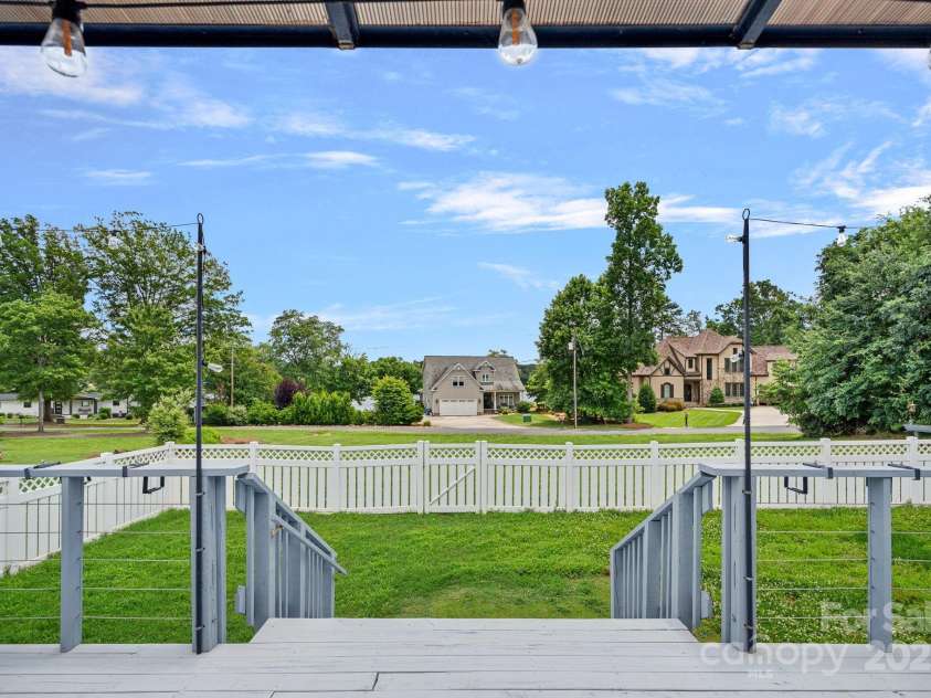 7478 Pine Ridge Drive, Denver, NC 28037.  MLS# CAR4272908, YatesRealty ID 25697. Unwind on the raised back deck while taking in peaceful Lake Norman views—morning coffee or evening sunsets never looked better.
