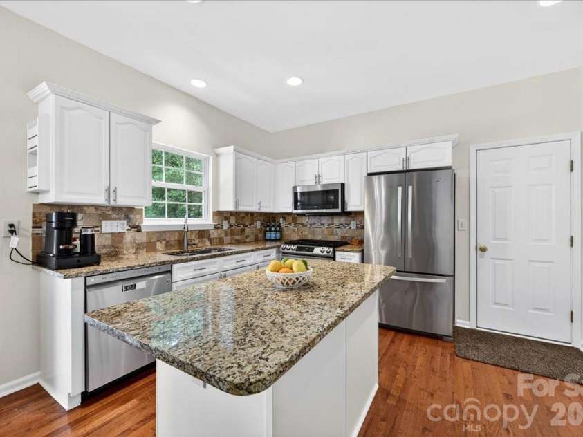 13209 Alex Mill Drive, Pineville, NC 28134.  MLS# CAR4377653, YatesRealty ID 25705. Garage access is conveniently located off the kitchen.
