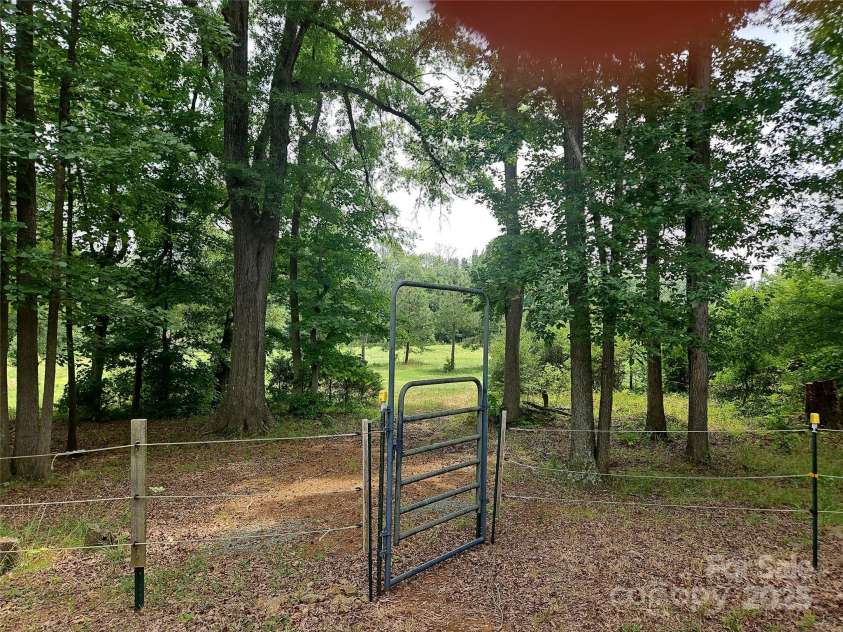2905 Medlin Road, Monroe, NC 28112.  MLS# CAR4267802, YatesRealty ID 25705. View of current fence leading to pasture