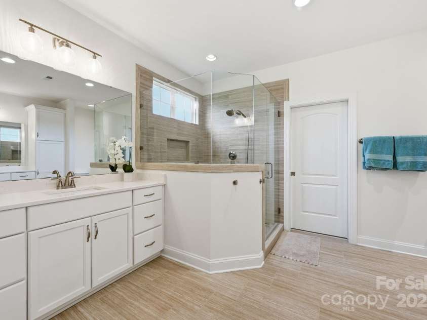 4058 Sagemont Drive, Concord, NC 28027.  MLS# CAR4318082, YatesRealty ID 2572. Large primary bath with separate vanities and large walk in shower