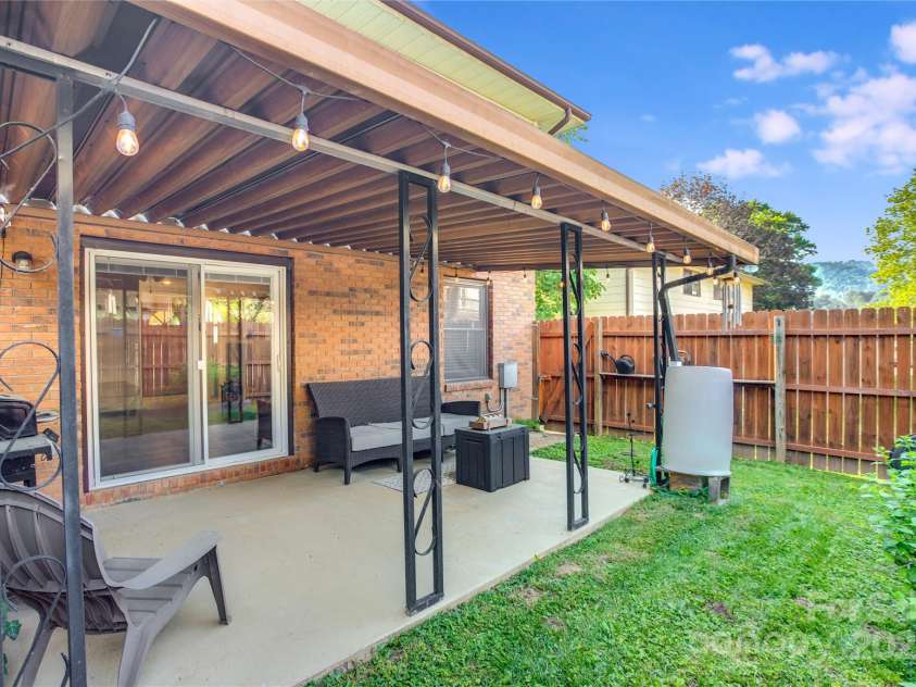 26 Pebblebrook Street, Clyde, NC 28721.  MLS# CAR4268095, YatesRealty ID 25732. Covered rear patio and fenced backyard.