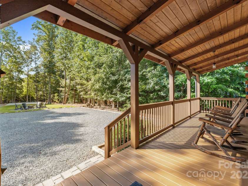 10108 Saw Mill Road, Charlotte, NC 28278.  MLS# CAR4268919, YatesRealty ID 25740. Rocking chair front porch overlooking a fire pit area and the pickleball court