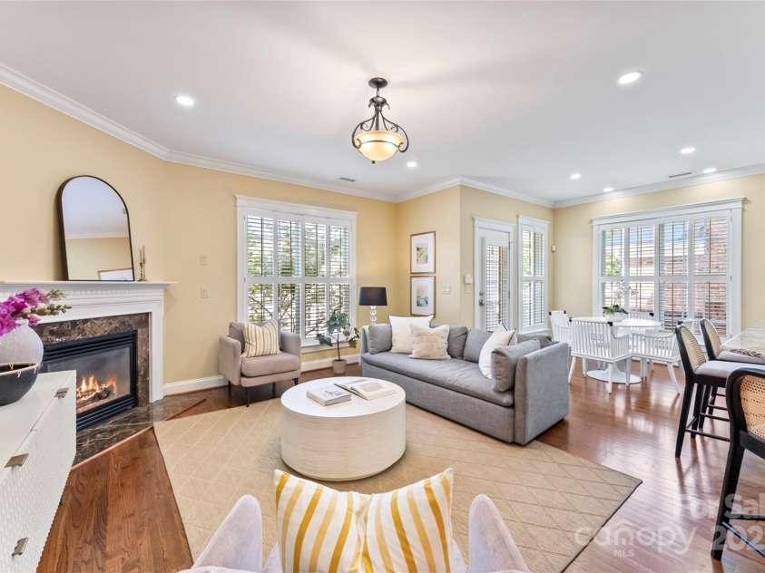 108 Forrester Avenue, Belmont, NC 28012.  MLS# CAR4265770, YatesRealty ID 25744. The Living room is open to the Kitchen and features another table to enjoy meals or refreshments.  Very sunny and open areas blend seamlessly together! The French door leads to the third covered porch and then to the am