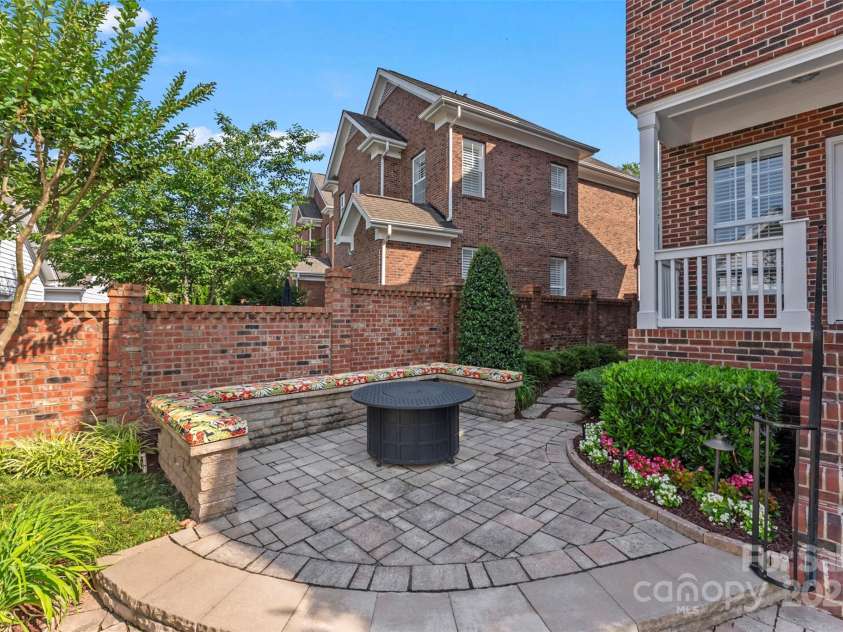 108 Forrester Avenue, Belmont, NC 28012.  MLS# CAR4265770, YatesRealty ID 25744. The outdoor terrace is a dream oasis!  This features a custom seating area around the fire table!  The floor is stone and outlines this portion of the terrace!  A brick wall surrounds the entire outdoor retreat!