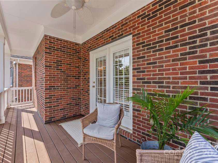 108 Forrester Avenue, Belmont, NC 28012.  MLS# CAR4265770, YatesRealty ID 25744. This spacious and welcoming covered front porch has seating to enjoy and relax in the peaceful neighborhood of Hawthorne!  The ceiling fan completes this unique porch!