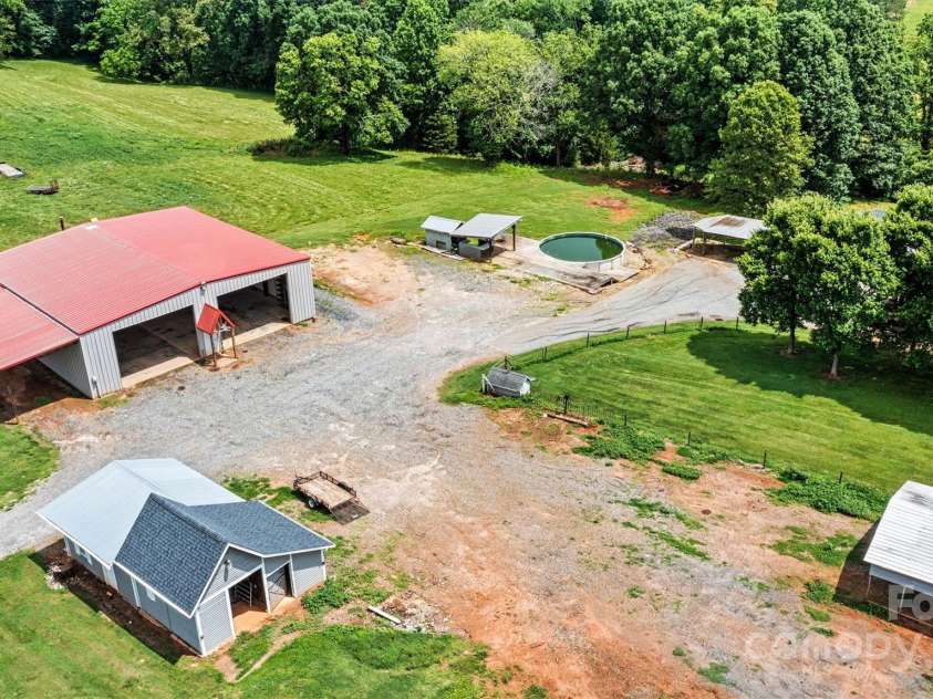 3724 County Home Road, Conover, NC 28613.  MLS# CAR4275725, YatesRealty ID 25751. Aerial Building View - 35 x 24 Metal Canopy Carport, 17 x 20 Pole Shed, 60 x 60 Metal Shop w/16 x 40 Lean To, 768 Sq Ft Outbuilding, 24 x 28 Detached Carport *By House)