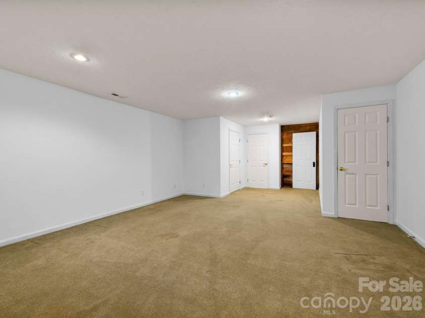 37 Leatherwood Drive, Candler, NC 28715.  MLS# CAR4376131, YatesRealty ID 25753. Lower-level Den area